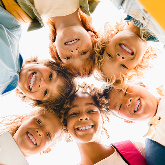 kids standing in a cirlce smiling